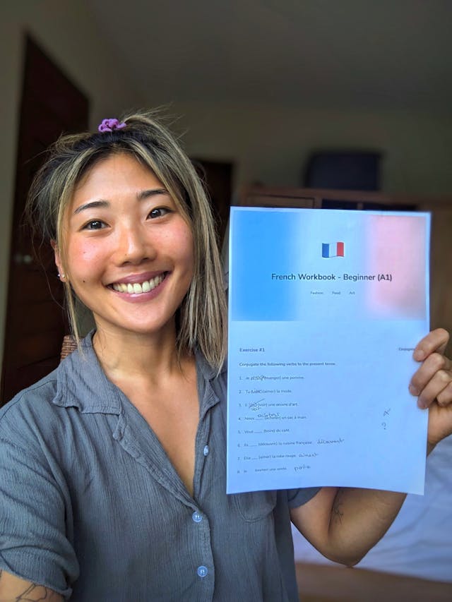 A student learning Korean with a printable workbook from WorkbookPDF